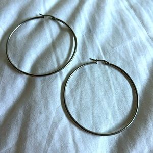 Silver hoop earrings, about 2” diameter. Purchased vintage in Brooklyn NY.